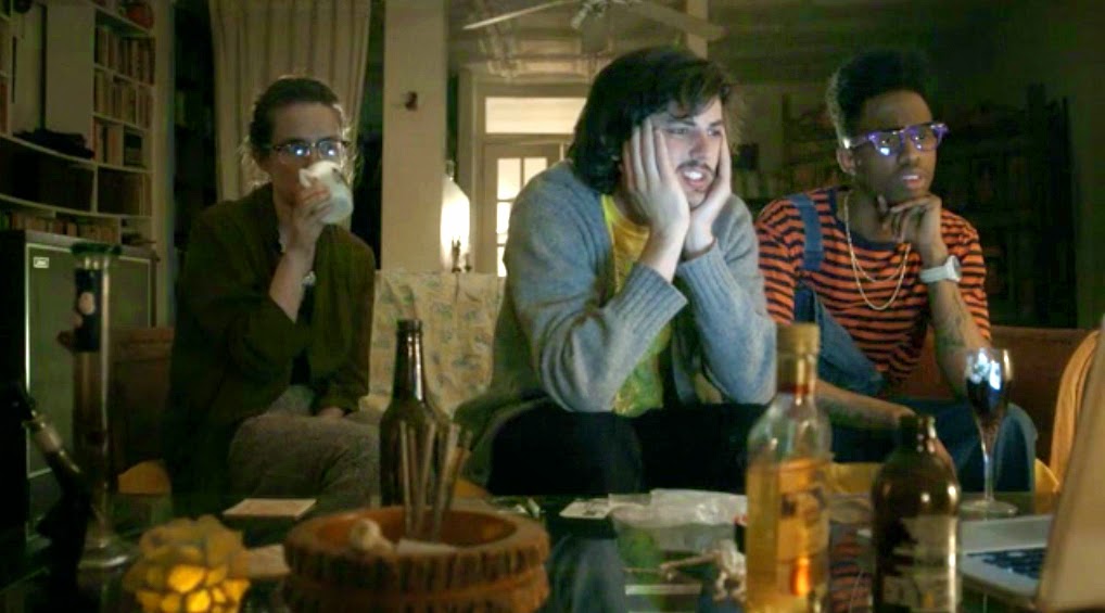 Hellaware movie scene: Three friends watch a screen with drinks and snacks. Indie film, Michael M. Bilandic.