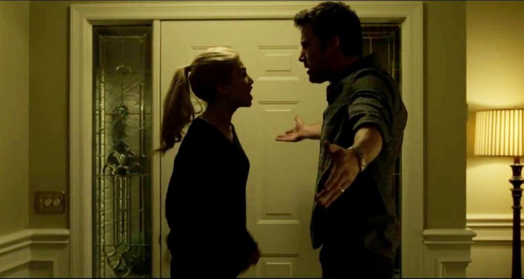 Ben Affleck and Rosamund Pike argue in Gone Girl, directed by David Fincher. Tense scene.