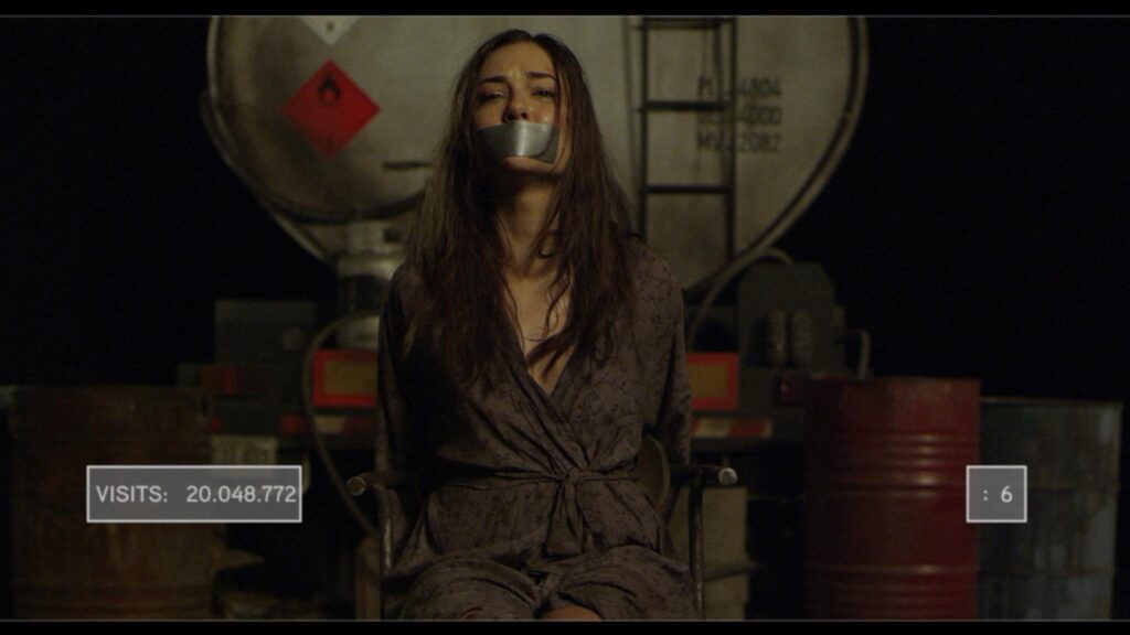 Open Windows movie scene: Woman with tape over mouth, tied to chair. Dark thriller, suspense.