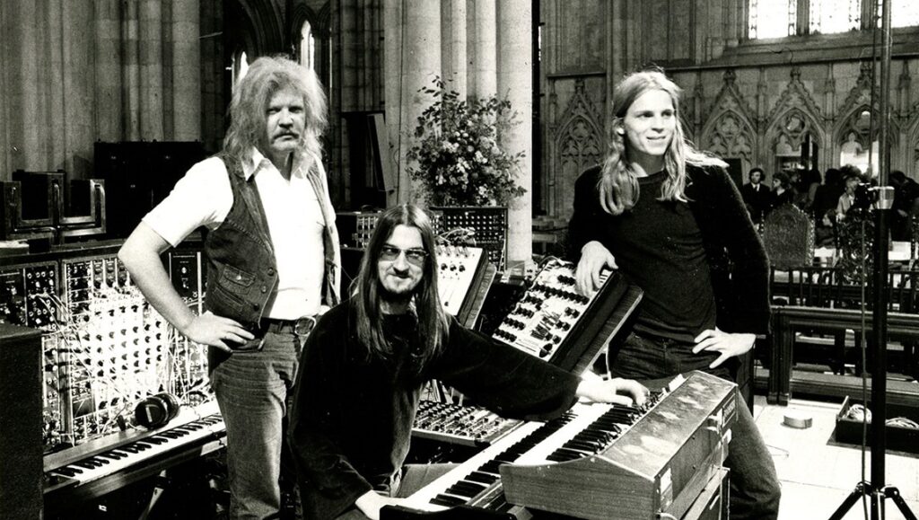 Tangerine Dream band members with synthesizers. Phaedra era promotional shot. Black and white.