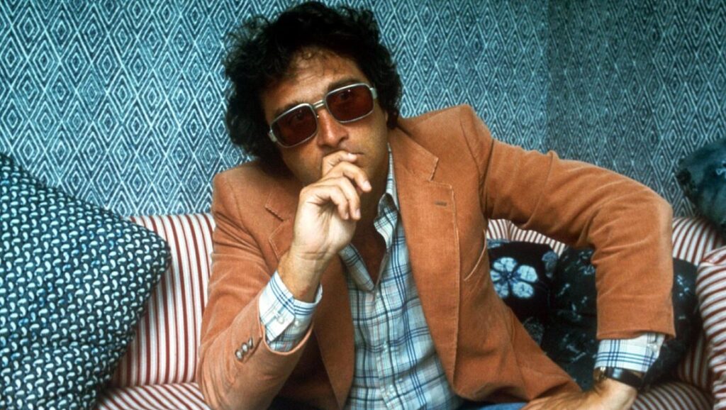 Randy Newman | Good Old Boys Randy Newman, Good Old Boys era. Singer-songwriter in sunglasses and a brown jacket.