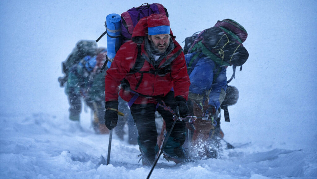Climbers on Everest battling a blizzard. Mountaineers ascend snowy slopes with ice axes and heavy backpacks. Extreme weather conditions.