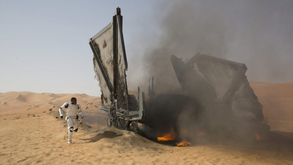 Star Wars: The Force Awakens | J.J. Abrams Star Wars: The Force Awakens. Finn runs from a crashed, burning ship on a desert planet.