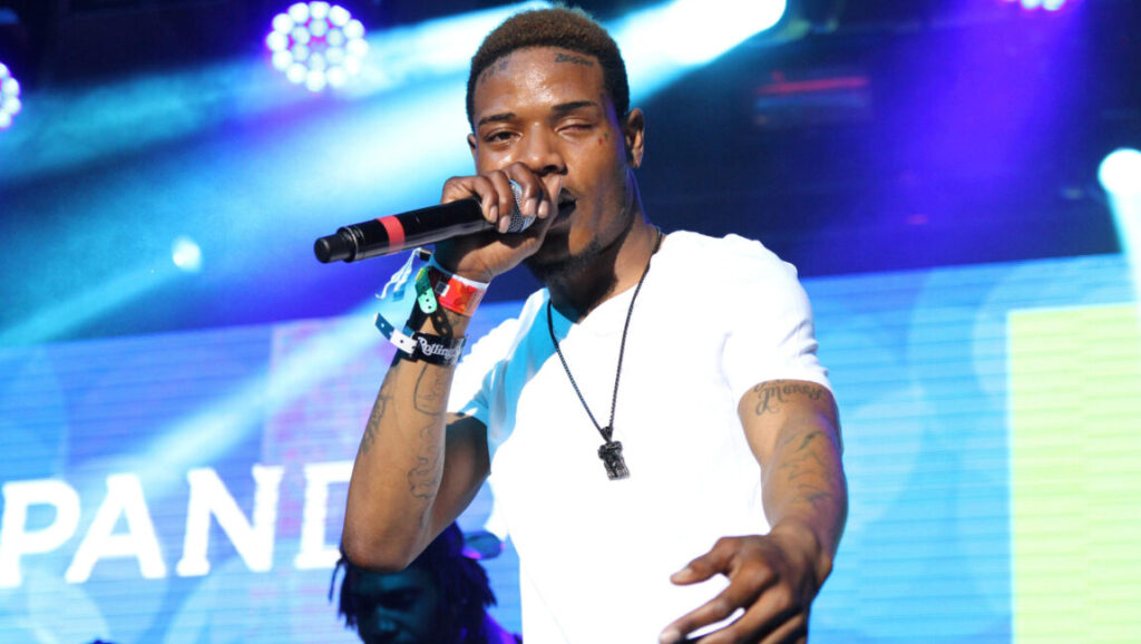Top 10 Songs of 2015 Fetty Wap performing live, top songs of 2015. Rapper on stage.