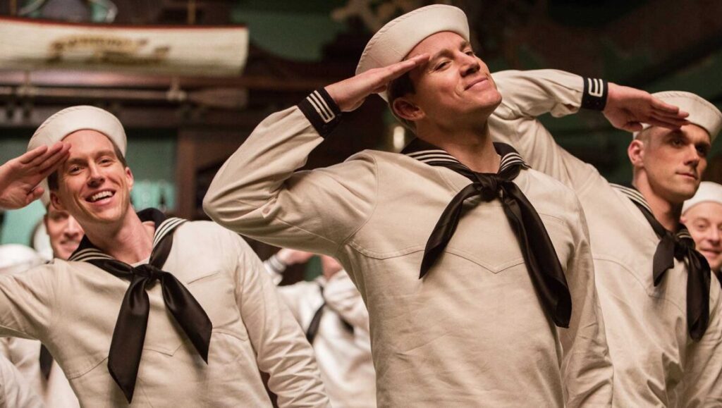 Channing Tatum in Hail, Caesar! movie. Sailors in uniform saluting. Coen Brothers film.
