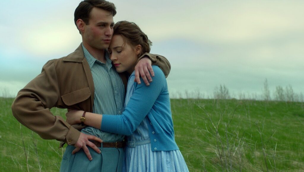 Brooklyn | John Crowley Brooklyn movie still: A young couple embraces in a field. Saoirse Ronan stars in this Wilson Yip film.