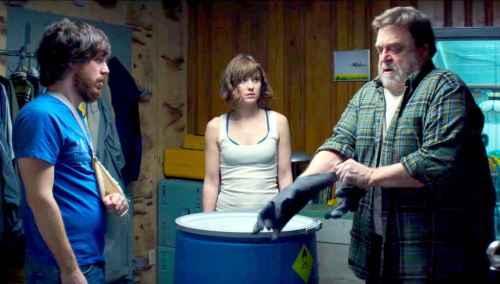 10 Cloverfield Lane movie scene. John Goodman, Mary Elizabeth Winstead, and John Gallagher Jr. in bunker.