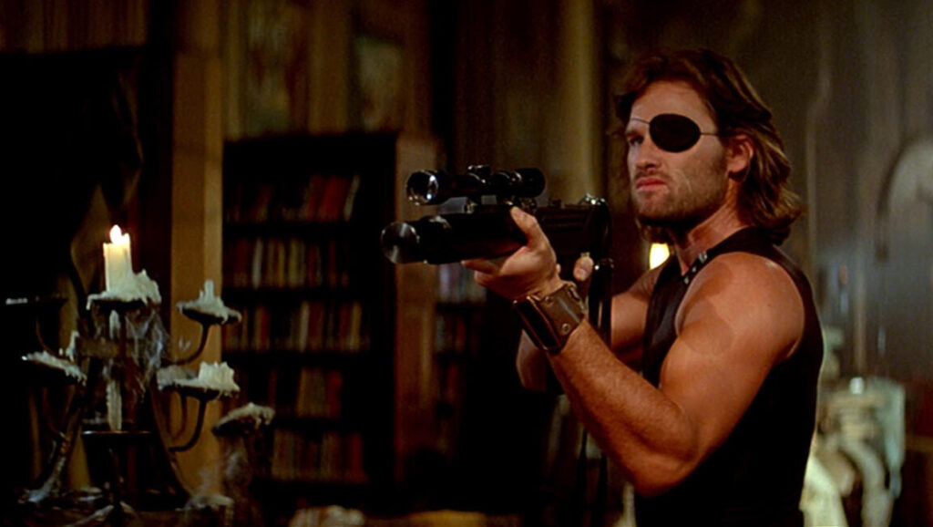 Escape from New York | John Carpenter Kurt Russell as Snake Plissken in John Carpenter's Escape from New York. Eyepatch, gun.