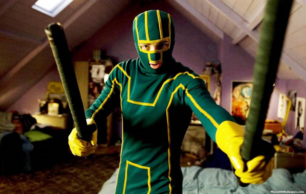 Kick-Ass | Matthew Vaughn Kick-Ass character in green and yellow suit holding batons. Matthew Vaughn film.
