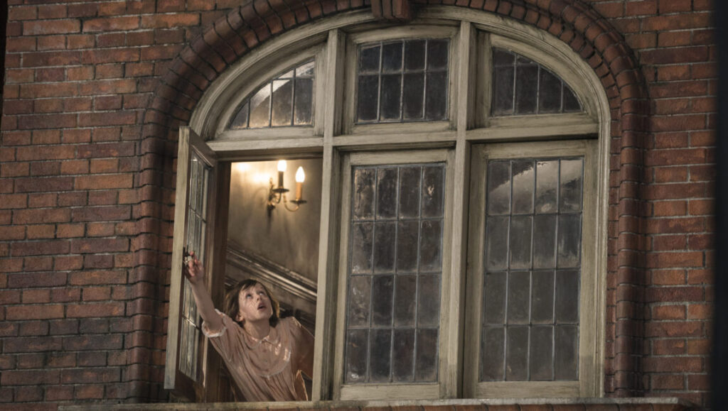 Ruby Barnhill as Sophie in The BFG movie. Girl looking out of window.