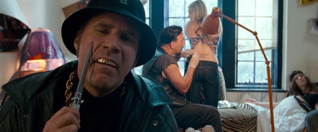 The Other Guys | Adam McKay Will Ferrell in The Other Guys movie. Ferrell, wearing a hat and gold chain, holds a knife to his face.