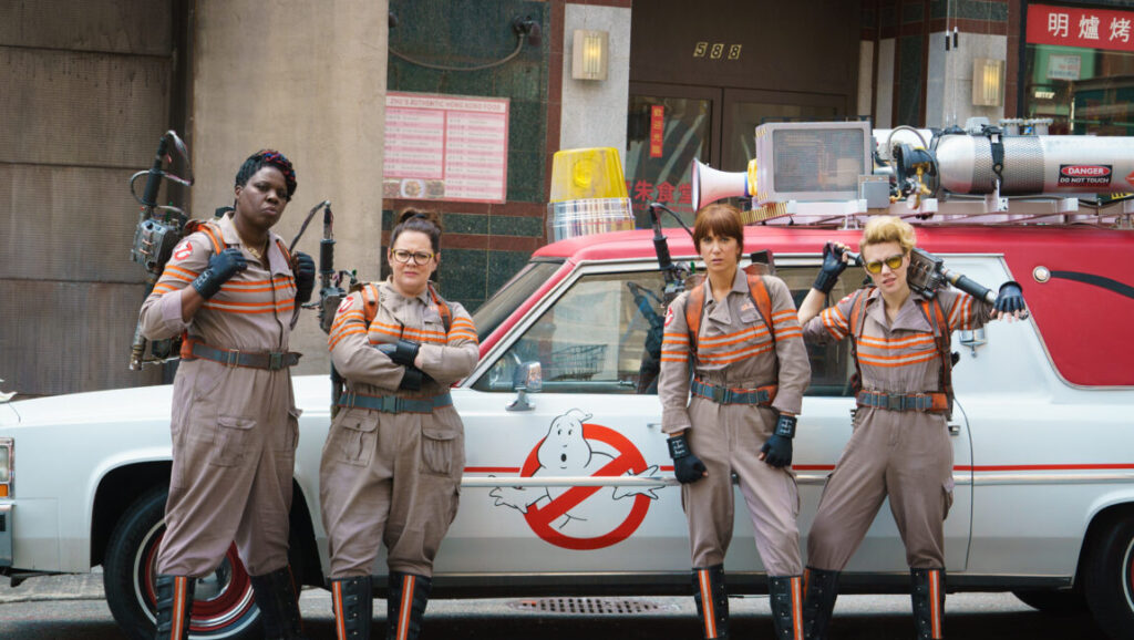 Ghostbusters | Paul Feig The 2016 Ghostbusters cast: Leslie Jones, Melissa McCarthy, Kristen Wiig, and Kate McKinnon with the Ecto-1 car.