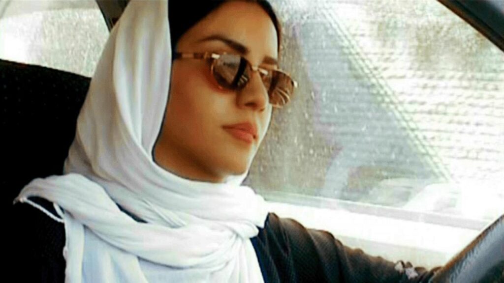 Still from Ten by Abbas Kiarostami. Woman in hijab and sunglasses driving. Iranian cinema.