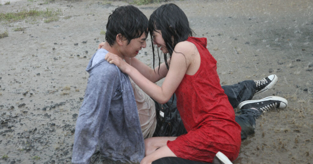 Himizu | Sion Sono Scene from Himizu by Sion Sono. Young couple embracing in the rain, faces close.
