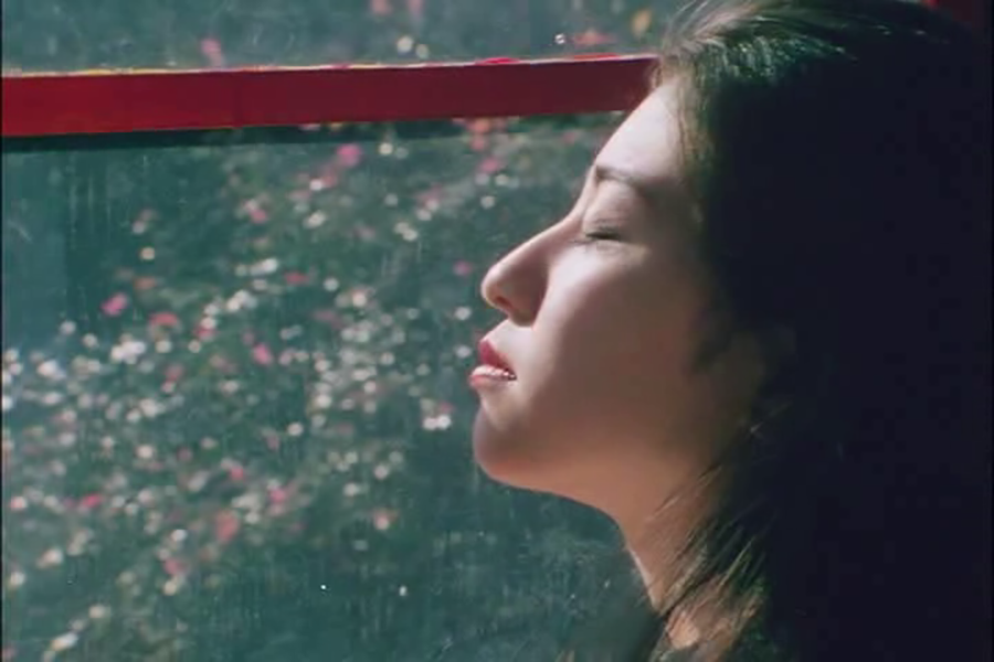 I Am Keiko | Sion Sono I Am Keiko movie still: Woman gazes out window, eyes closed. Sion Sono film.