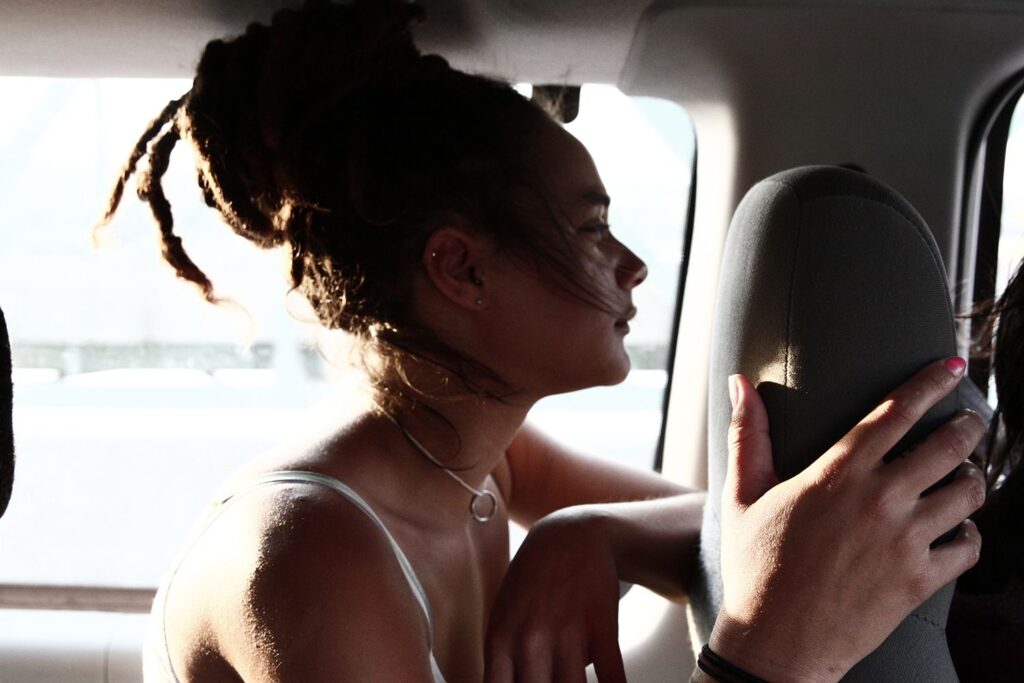 American Honey film still: Young woman with dreadlocks in a car. Andrea Arnold film.