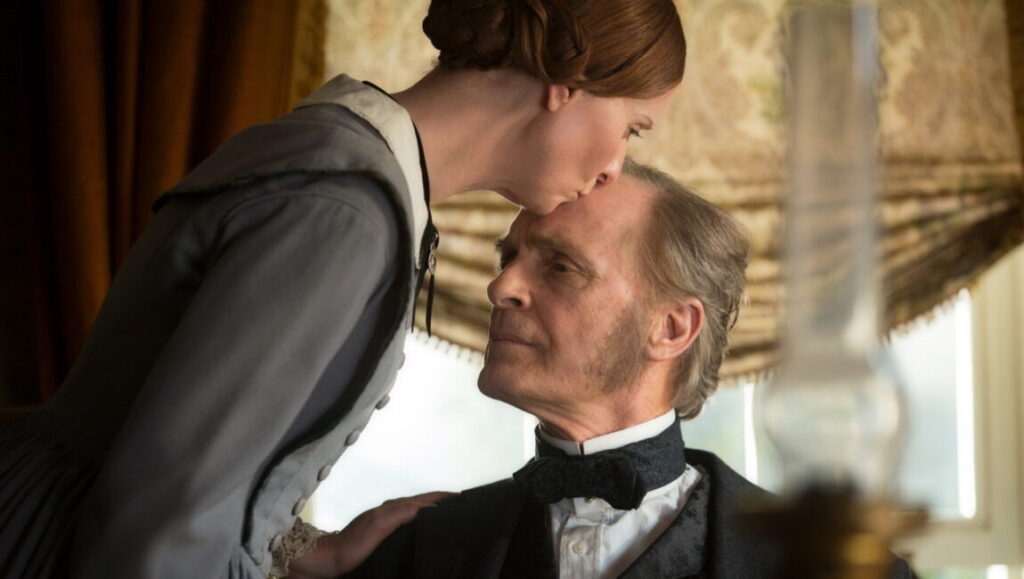Vancouver Film Festival: A Quiet Passion still. Woman kisses older man's forehead. Period drama.