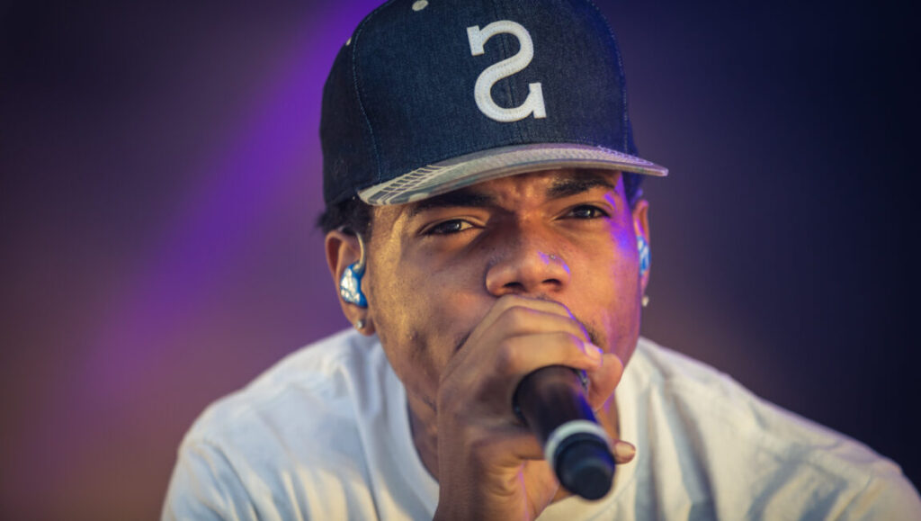Chance the Rapper, a top album artist of 2016, singing into a microphone.