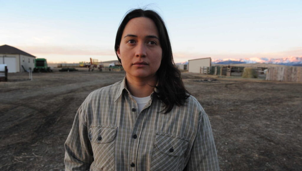 Lily Gladstone, a top performance of 2016, stands in a field. Gladstone wore a striped shirt.
