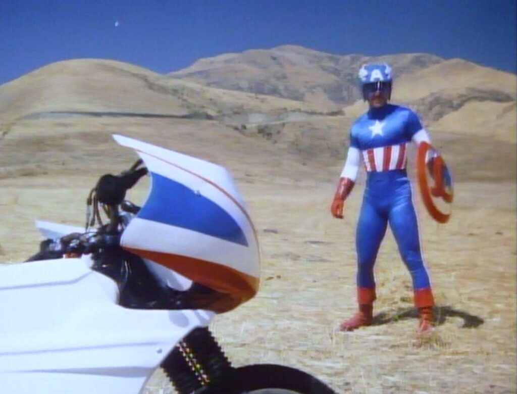 Bad Idea Podcast Episode 6: Captain America with motorcycle in desert landscape.