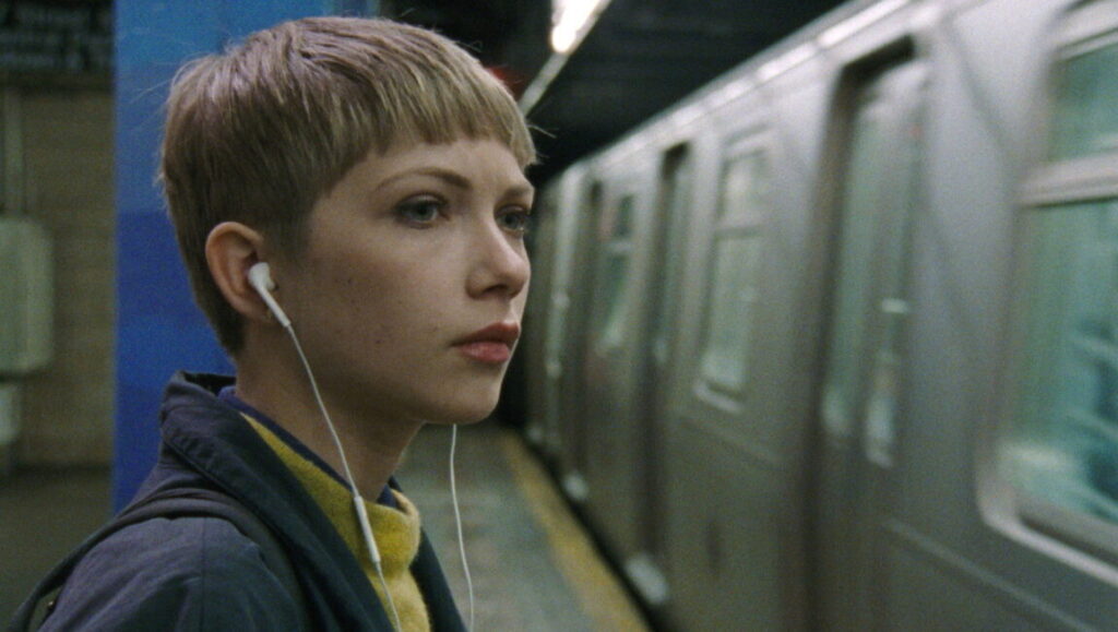 Person to Person film still. Woman with earbuds waits for a New York City subway train. New Directors/New Films 2017.