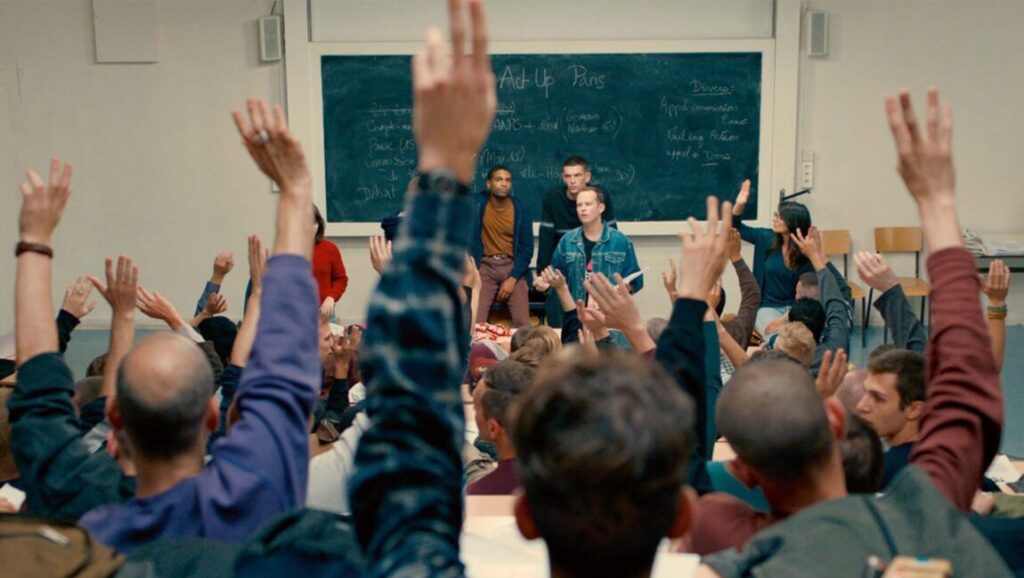 BPM (Beats Per Minute) film scene at Venice Film Festival. Group raising hands in a classroom.