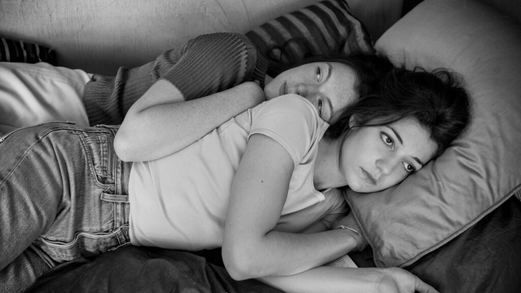 Black and white still from Lover for a Day at the New York Film Festival 2017. Two women lie on a bed.