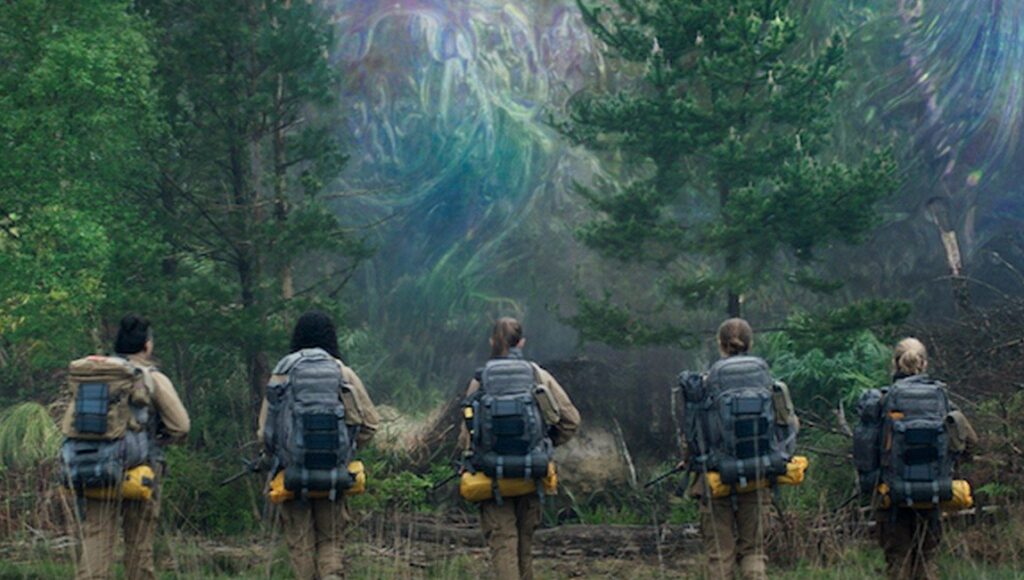 Annihilation movie scene. Team of explorers with backpacks in a forest facing a strange, colorful anomaly.