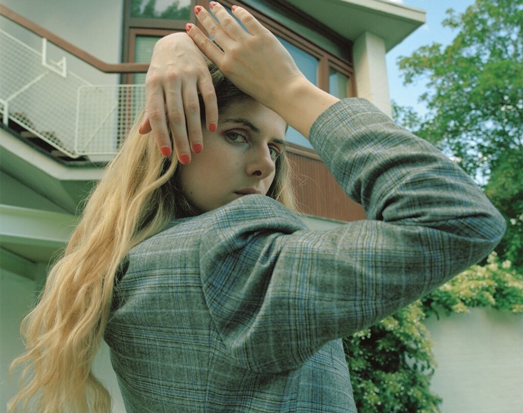 εὐδαιμονία | Issue I Eudaimonia Issue I: Woman with blonde hair and red nails in a plaid blazer.