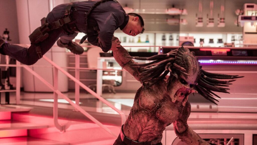 The Predator movie scene. Predator holding a man. Action scene from Shane Black's The Predator film.