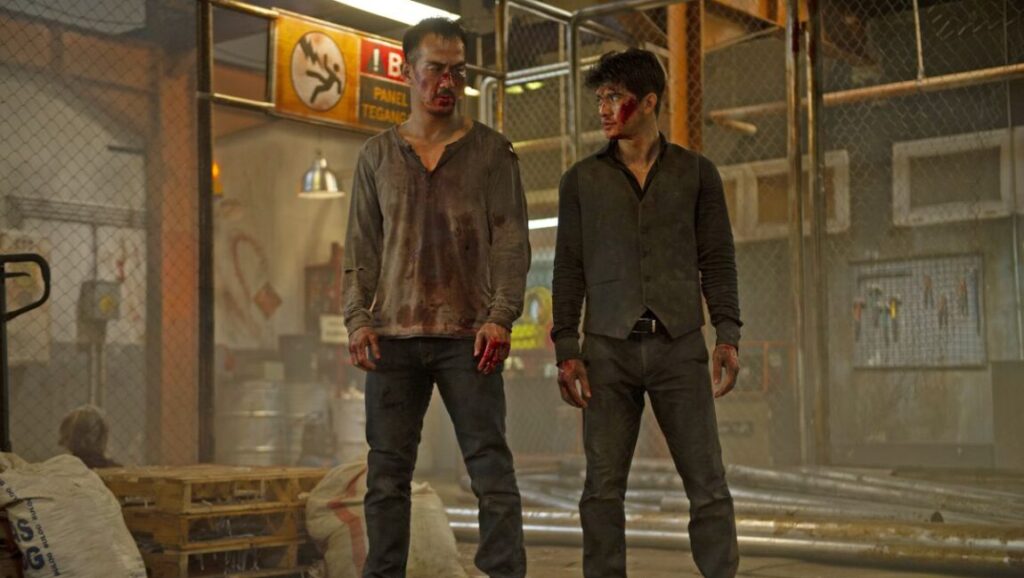 The Night Comes for Us movie scene. Two men, covered in blood, stand ready for action. Timo Tjahjanto film.