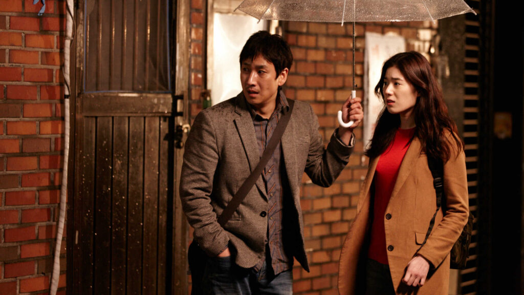 Nobody's Daughter Haewon film scene. Man and woman under umbrella. Hong Sang-soo movie.