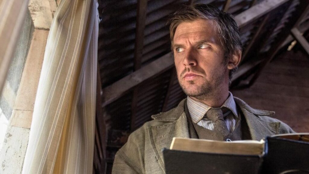 Dan Stevens as Apostle, Gareth Evans film. Man in period clothing holding a book, looking off to the side.