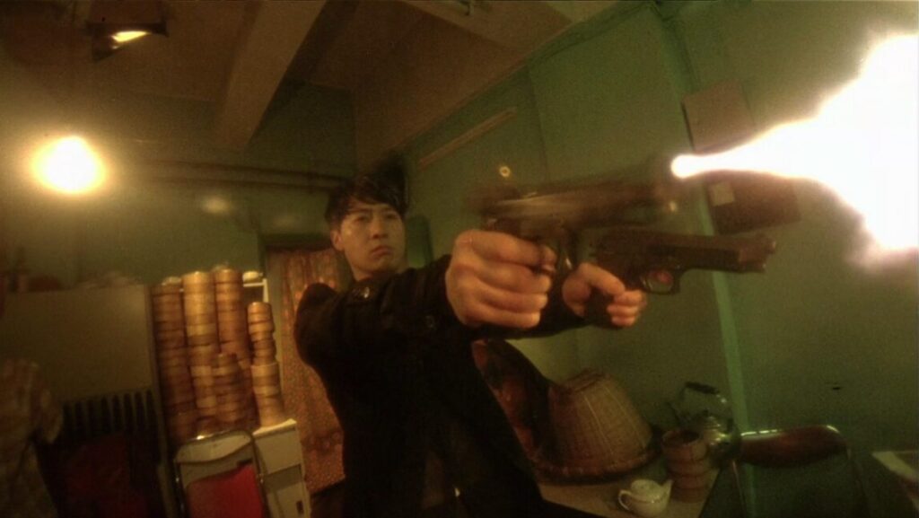 Wong Kar-wai's Fallen Angels: Man firing two guns. Action scene from the Hong Kong crime film.