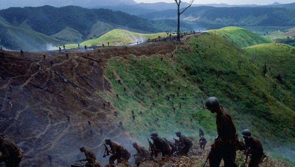 The Thin Red Line scene: Soldiers advance up a hill during WWII combat.