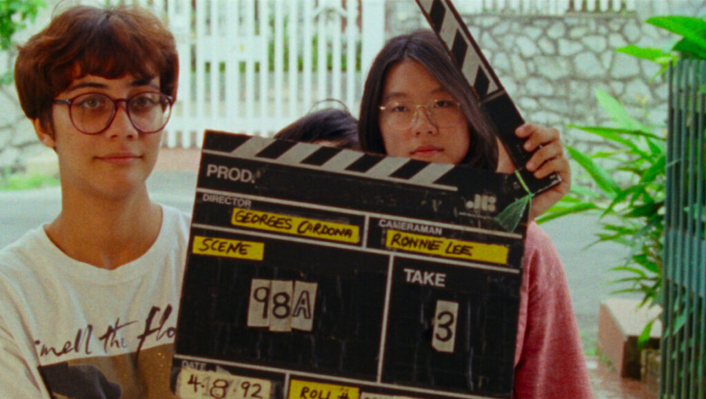 Shirkers | Sandi Tan Sandi Tan's Shirkers film still. Women hold a clapperboard, scene 98A, take 3, dated 4-8-92. Behind the scenes.