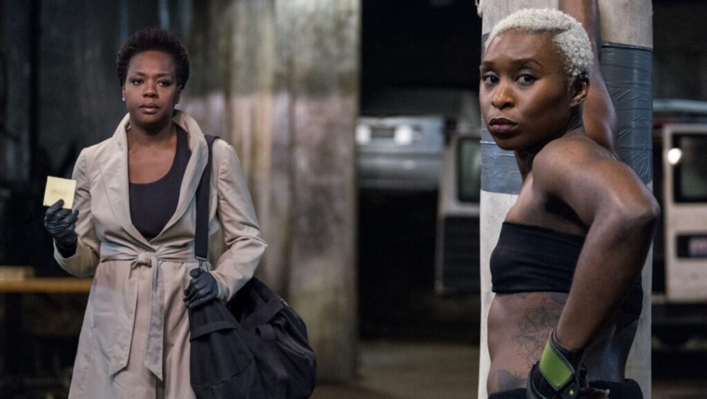 Viola Davis and Cynthia Erivo in *Widows*, directed by Steve McQueen. Davis holds a note, Erivo wears a black top.