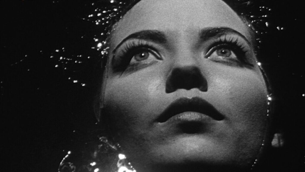 Close-up of a woman's face in Night Tide, a film by Curtis Harrington. Black and white, dramatic lighting.