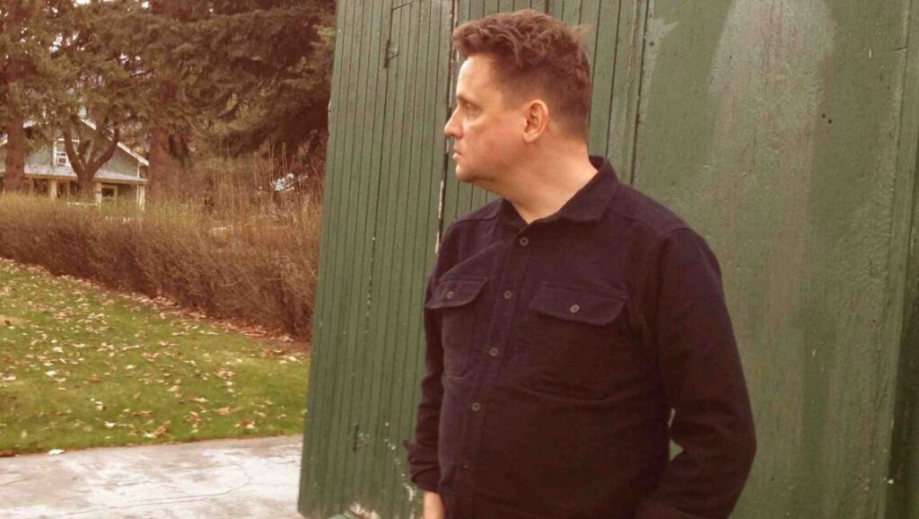 Sun Kil Moon | This Is My Dinner Sun Kil Moon's This Is My Dinner album art. Mark Kozelek, musician, stands outside. Green fence, house, and trees in background.