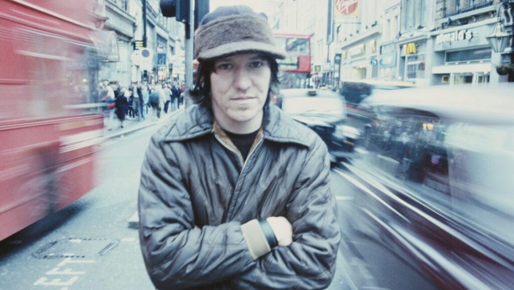Elliot Smith | XO Elliot Smith, XO album cover. Singer in London with buses and cars blurred around him.