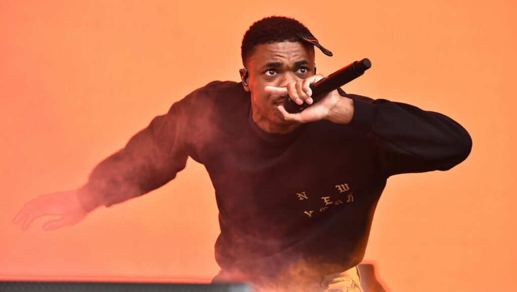 Vince Staples performs live. What Would Meek Do? music article. Concert. Rapper with microphone.