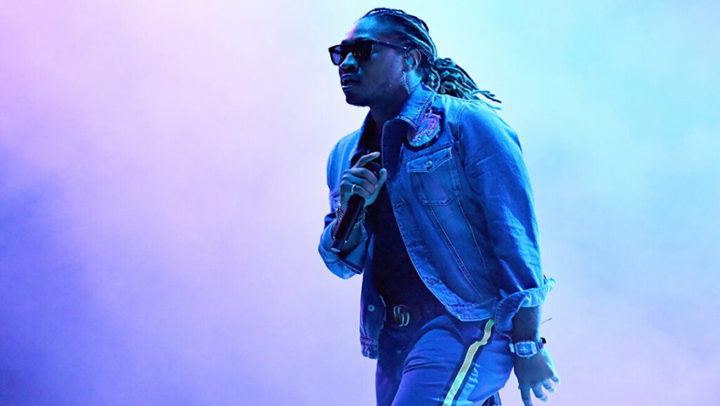 Future | Future Hndrxx Presents: The Wizrd Future performing live. Rapper Future promoting The Wizrd album. Concert stage with blue and purple lighting.