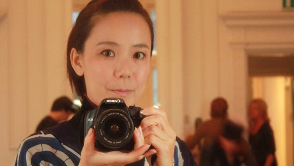 Naomi Kawase holds a camera. 'Radiance' film director, portrait. Japanese filmmaker.