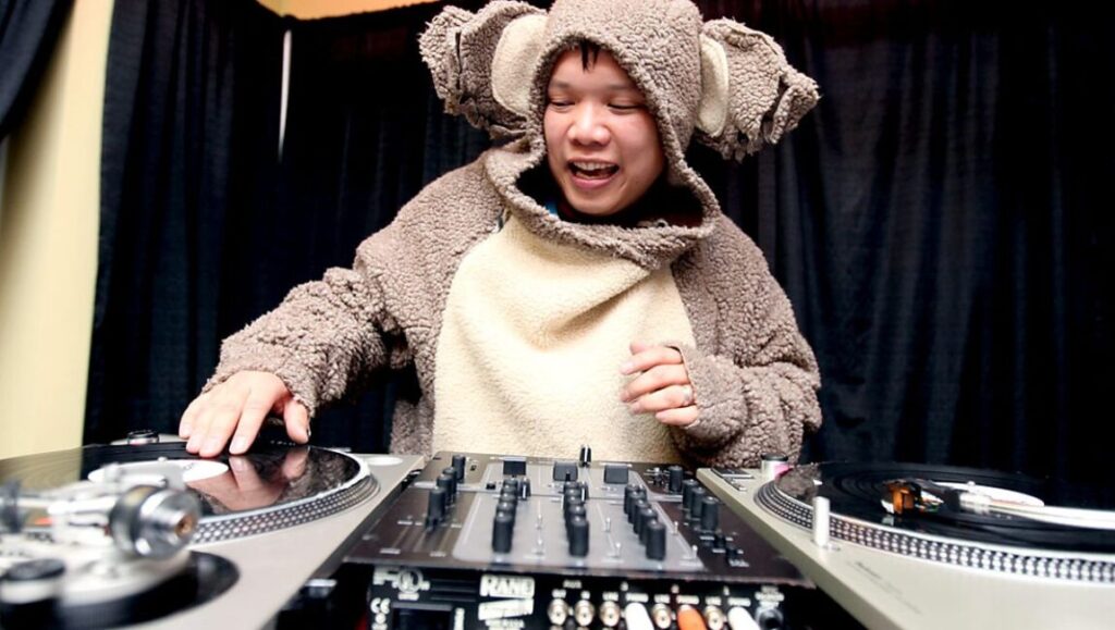 Kid Koala | Music to Draw To: Io Kid Koala, Music to Draw To: Io. DJ in a koala suit mixing music on turntables.