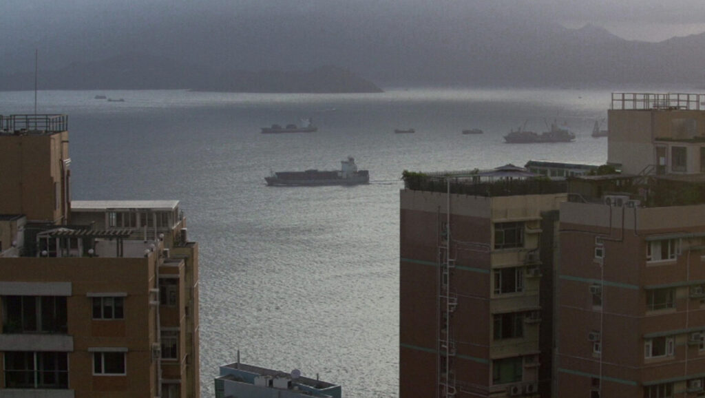 Taipei cityscape, Taiwan. Ships on the water, buildings in the foreground. Hsieh Chinlin, Taiwan New Cinema.