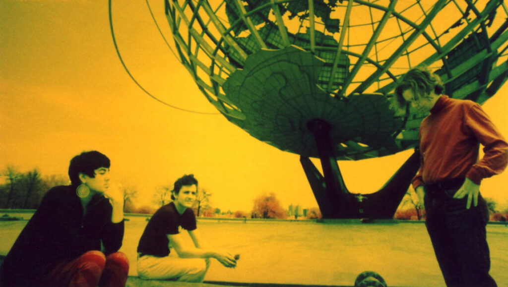 Galaxie 500 On Fire album art. Band members with the Unisphere at Flushing Meadows Corona Park in the background.
