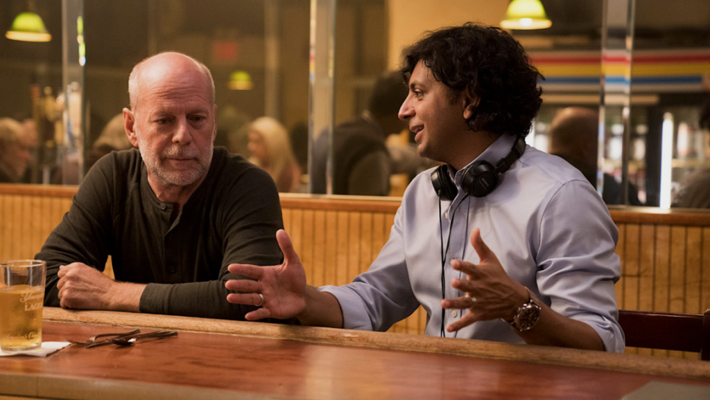 M. Night Shyamalan with Bruce Willis on the set of Glass. A decade of Shyamalan films.