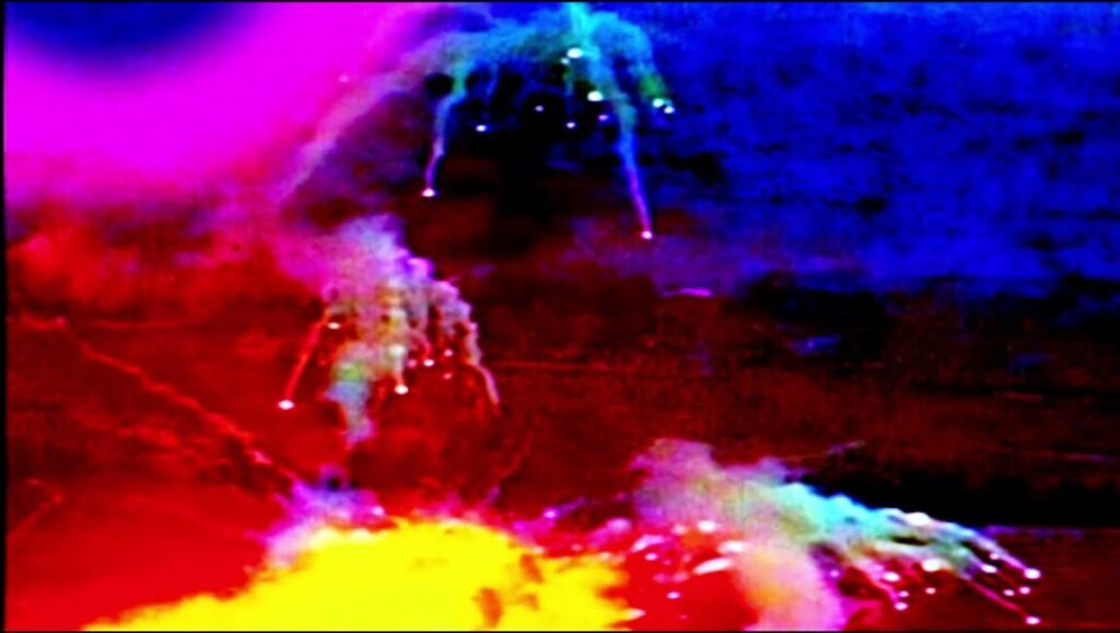 Abstract colorful image from The Image Book by Jean-Luc Godard. Features vibrant explosions and surreal visuals.