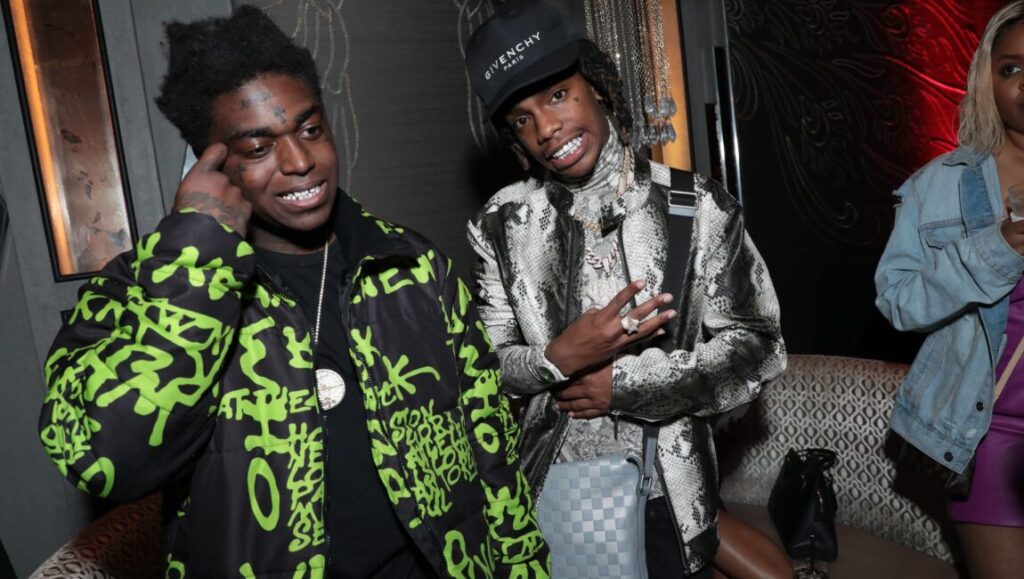 YNW Melly poses with Kodak Black. The rappers wear stylish jackets and jewelry. What Would Meek Do? article.