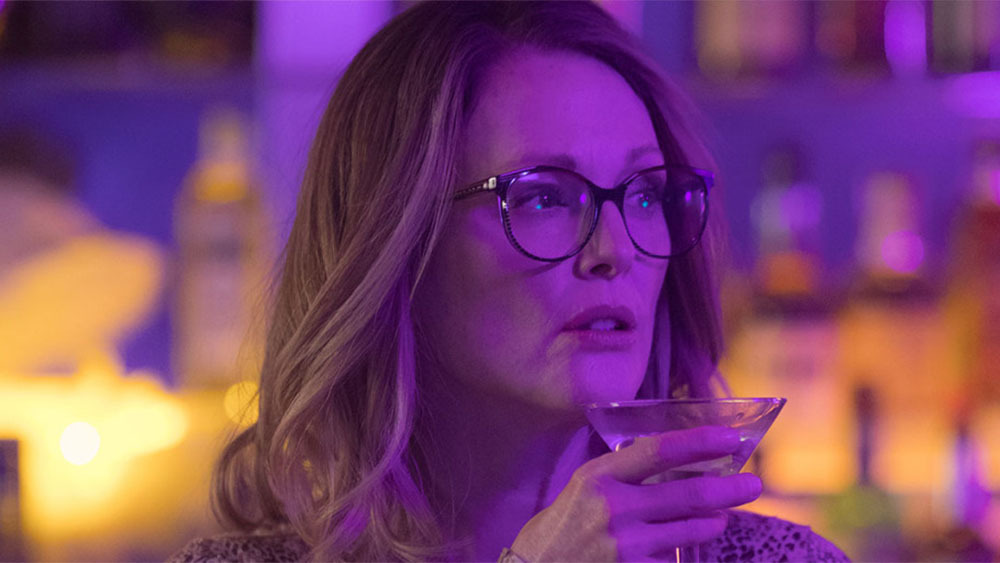 Julianne Moore as Gloria Bell, drinking a martini in Sebastian Lelio's film.